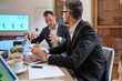 © Philippe Degroote/ADDICTIVE STOCK - Adult male managers in formal clothes sitting at table with diagrams and discussing results of marketing company during meeting in workspace