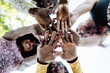 © Sergio Victor Vega/ADDICTIVE STOCK - From below of group of multiracial cheerful women standing together and stacking hands in name of unity and friendship