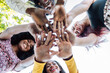 © Sergio Victor Vega/ADDICTIVE STOCK - From below of group of multiracial cheerful women standing together and stacking hands in name of unity and friendship