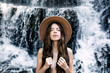 © Sergio Victor Vega/ADDICTIVE STOCK - Tranquil nude female covering breast with long hair standing on background of spectacular waterfall and enjoying fresh natural air with closed eyes