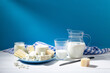 Dairy products on white wood base and blue background.