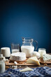 Dairy products on  wood base and blue background with  copy space. Vertical format.