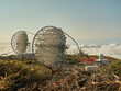 © Gabriel Trujillo/ADDICTIVE STOCK - Amazing view of modern telescopes on dark mountaintop against cloudy sky at astronomical observatory on island of La Palma in Spain