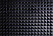 © Jose Carlos Gutierrez/ADDICTIVE STOCK - Textured background of wall with black geometric soundproof foam with pyramid shaped pattern in recording studio