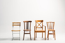 Four Classical Wooden Chairs Against White Background