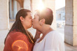 © Si And Si/ADDICTIVE STOCK - Side view of homosexual couple of women kissing with closed eyes near old house in sunlight in back lit