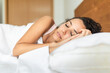 © Sergio Victor Vega/ADDICTIVE STOCK - Calm female in pajama lying in bed on soft pillow under white blanket and sweetly sleeping