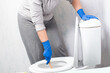 Cleaning stuck in toilet. Woman clean a clogged toilet.