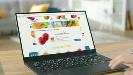 Wall Mural - Person Uses Laptop Computer Browsing through Online Food Delivery Market, Choosing Vegetables in Fresh Goods Section. Internet Store with List of Products to Order. POV view