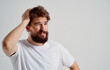 © SHOTPRIME STUDIO - man bearded man in white t-shirt holding his head discontent depression emotions