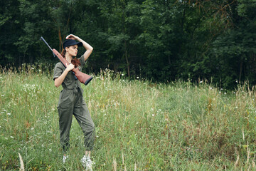 Wall Mural - Woman on nature Arms on shoulder travel hunting lifestyle black cap 