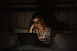 © New Africa - Young woman using laptop in bed at night. Sleeping disorder problem