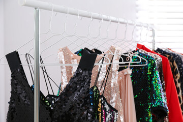 Poster - Stylish party dresses on rack indoors, closeup