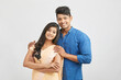 © krishna - Cheerful Indian young couple in traditional outfit against white.