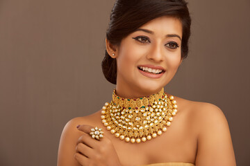 Beautiful Indian young women portrait with Indian traditional jewelry studio shot.