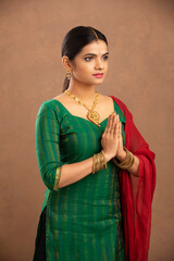 Canvas Print - Pretty Indian young woman praying studio shot
