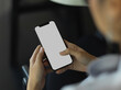 © bongkarn - Cropped shot of female hand using smartphone in blurred background