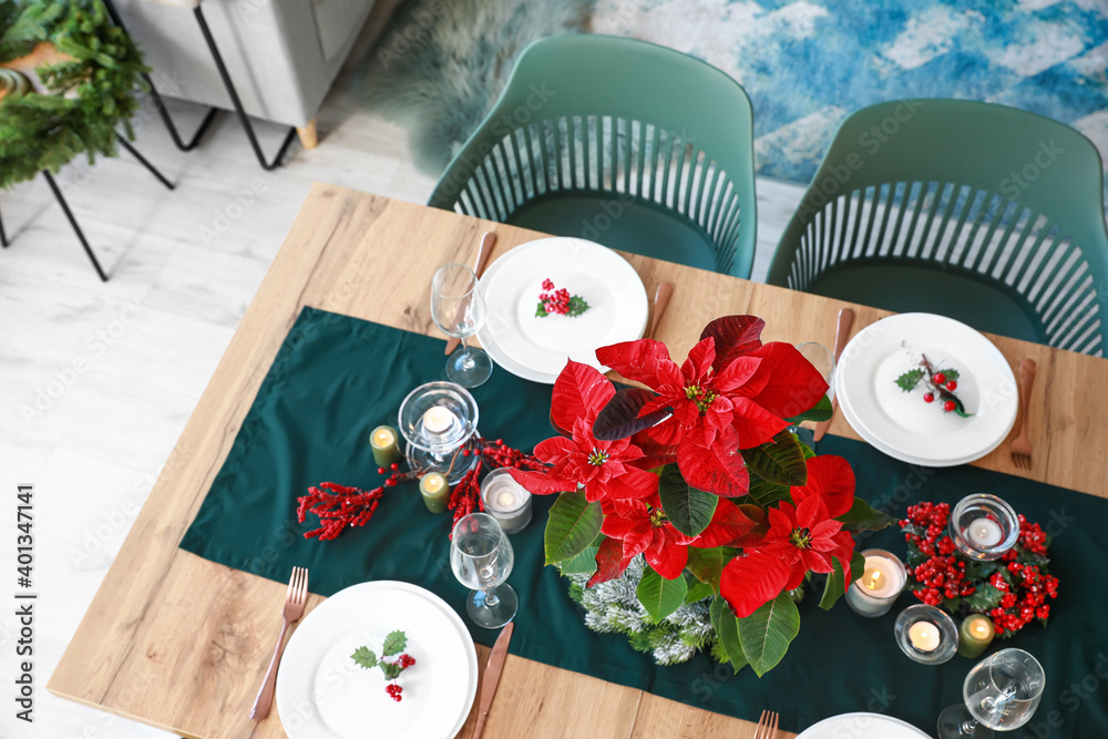 Christmas table setting with poinsettia in living room