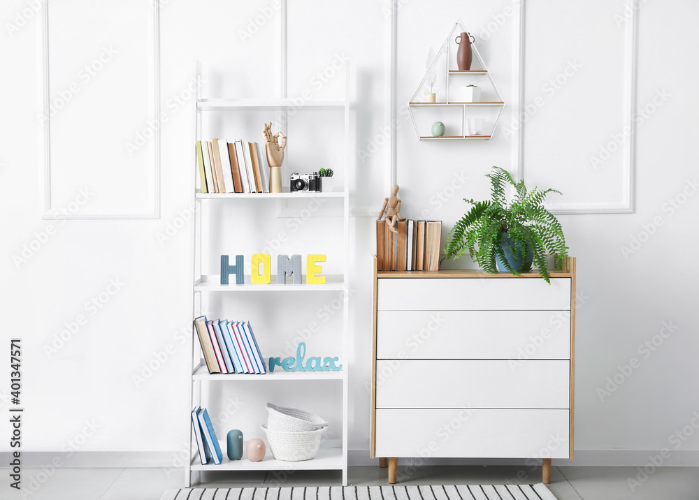 Interior of modern room with shelf unit and commode