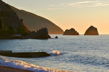 Sea surf, silhouettes of rocks on the Black sea in the village of Gurzuf