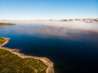 Wall Mural - Clouds over lake water, Hardangervidda landscape, Norway