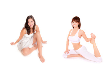 Two attractive smiling women wearing white clothes, isolated in front of white studio background