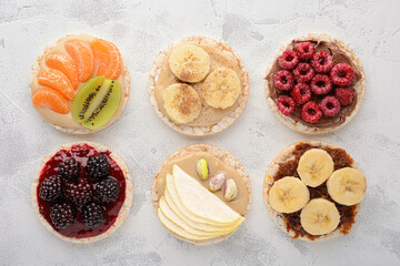 Top view rice cakes with various topping on a wooden background