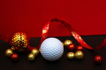 Golf ball for Chinese New Year gits on red background 