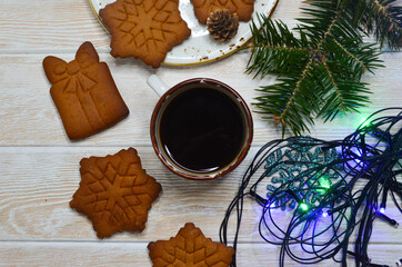 Wall Mural - New Year's atmosphere, Christmas mood and coziness, warming winter coffee drink, relaxation at home on holiday, snowflake-shaped cookies, holiday baked goods