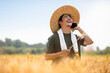 © Blue Jean Images - Farmer talking on smartphone in wheat field