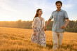 © Blue Jean Images - Happy young couple having fun in wheat field