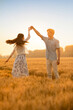 © Blue Jean Images - Happy young couple having fun in wheat field