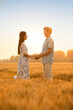 © Blue Jean Images - Happy young couple having fun in wheat field