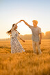 © Blue Jean Images - Happy young couple having fun in wheat field