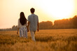 © Blue Jean Images - Happy young couple having fun in wheat field