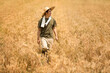 © Blue Jean Images - Farmer harvesting in wheat field