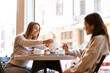 © Drobot Dean - Two lovely smiling young women friends having lunch