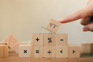 Math symbols written on the wooden blocks of a businessman With calculations with ideas A concept, a difficult problem or a mathematical solution