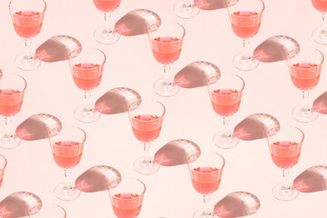 Wall Mural - Creative pattern made with champagne glass. Minimal pastel pink New Year party background.