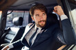 © SHOTPRIME STUDIO - successful rich man in a suit talking on the phone while driving a passenger car