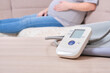 © Natasha - blood pressure monitor and pregnant woman on the couch