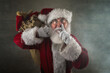 © soupstock - Santa Claus laying a finger aside of his nose in the chimney