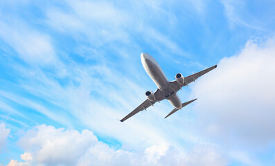 White passenger airplane over the clouds  - Travel by air transport