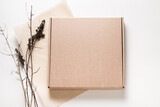 Fototapeta Lawenda - Brown cardboard box, minimalism style decorated with dried brunches