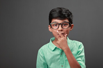 Wall Mural - Smart little boy smiles with surprise