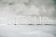 Name JESUS made with cement letters on grey marble background. Copy space. Biblical, spiritual or christian reminder