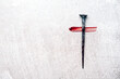 Christian cross made with rusty nails, drops of blood on grey background. Copy space. Good Friday, Easter day. Christian backdrop. Biblical faith, gospel, salvation concept. Jesus Christ Crucifixion