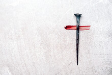 Christian Cross Made With Rusty Nails, Drops Of Blood On Grey Background. Copy Space. Good Friday, Easter Day. Christian Backdrop. Biblical Faith, Gospel, Salvation Concept. Jesus Christ Crucifixion