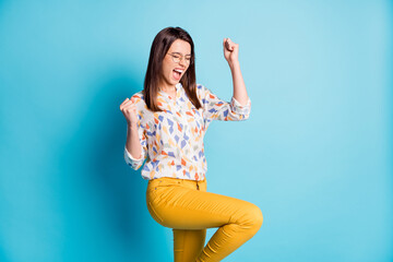 Poster - Profile photo of cute young girl raise fist knee wear spectacles geometry print shirt yellow pants isolated blue color background