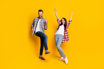 Canvas Print - Full length photo portrait of excited crazy couple celebrating isolated on vivid yellow colored background